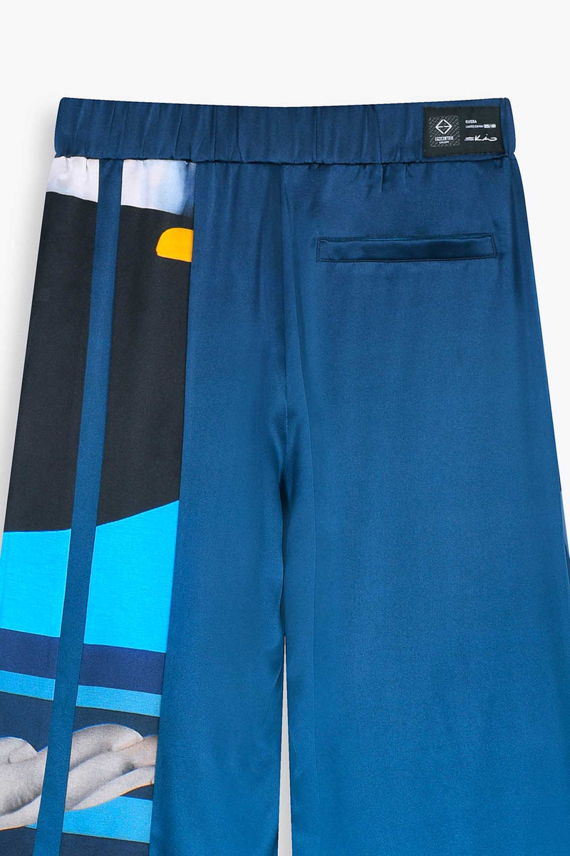 Zoom de dos avec Etiquette collection Egocentrik Pantalon 100% soie  bleu avec oeuvre de l'artiste SKIO "Riviera" 